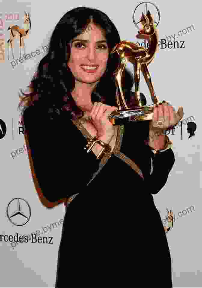 Salma Hayek Accepting An Award, Her Eyes Filled With Pride And Accomplishment. Salma Hayek: An Unauthorized Biography